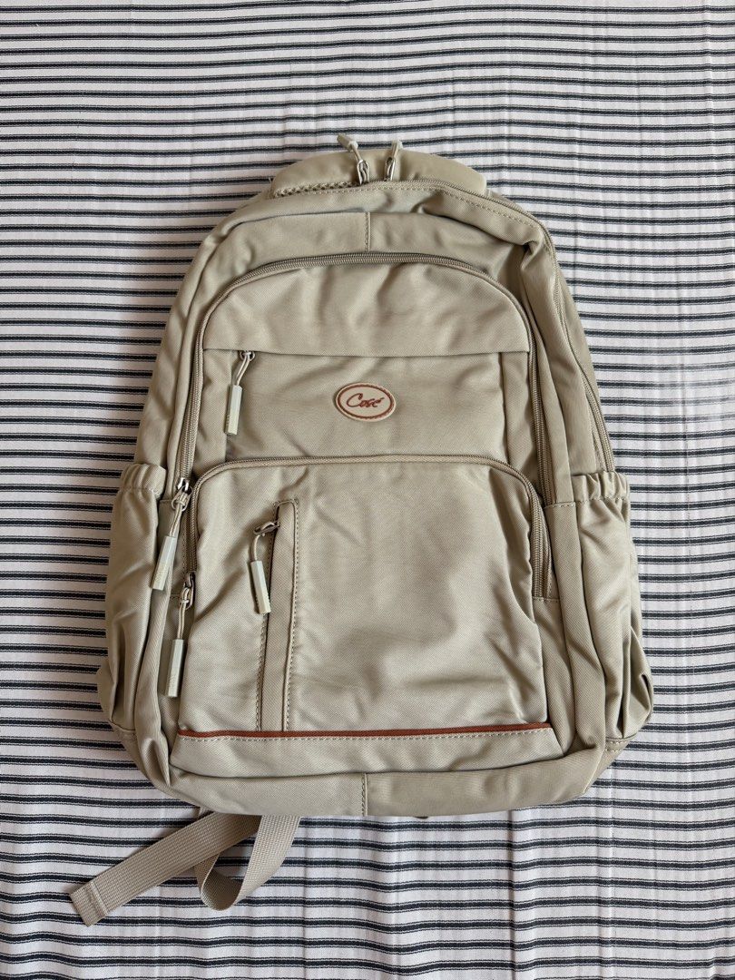 Cose Beige Casual Backpack with Multiple Compartments (Category: Backpacks) located in Cavite. Submitted by chinitolover (Listing ID 1465769921, Image 2). Description: - NEVER BEEN USED - Material: Sturdy canvas - Compartments: Main zip compartment and front zipped pocket - Pouch: Two side water bottle pouches - Comfort: Padded shoulder straps with adjustable buckles - Best for: Everyday campus use or travel.