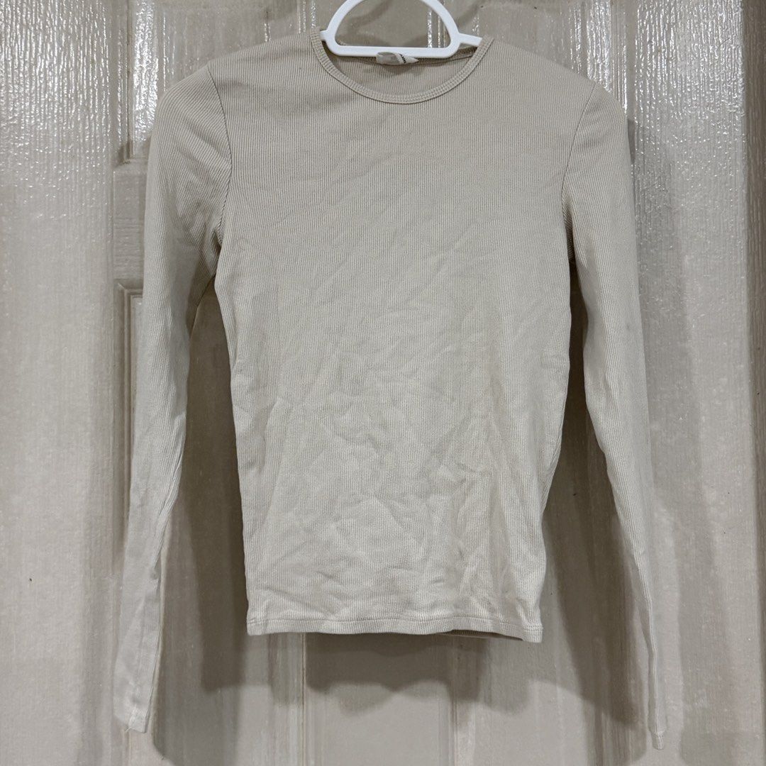 Cotton On beige ribbed long sleeve top (Category: Longsleeves) located in Makati City. Submitted by julyco. (Listing ID 1465804034, Image 1). Description: - Brand: Cotton On - Style: Ribbed long-sleeve top with crew neckline and fitted silhouette - Color: Neutral beige - Size: XS (Made in Bangladesh) - Material: Soft and stretchy fabric - Condition/Details: Versatile everyday basic, perfect for pairing with high-waisted jeans or skirts.