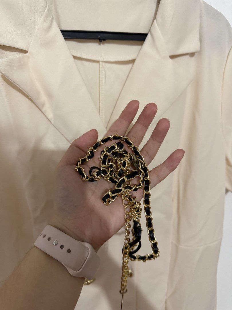 Cream Double-Breasted Blazer Dress with Chain Strap (Category: Dresses) located in Las Pinas. Submitted by milkydeclutter (Listing ID 1465940179, Image 2). Description: - Color: Cream - Style: Double-breasted blazer dress with lapel collar and short sleeves - Accents: Gold-toned buttons, pleated ruffle hem, and pleated pocket details - Accessory: Includes a chic gold and black interwoven chain belt - Fabric: Smooth finish for a polished look - Co