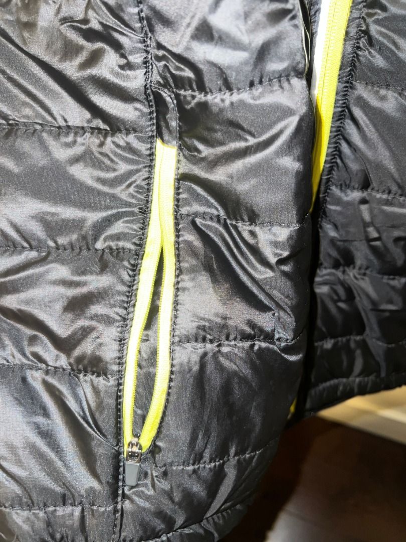 Crivit Black and Lime Green Running Jacket [j4] (Category: Activewear) located in Pasig City. Submitted by awesamfinds (Listing ID 1465839573, Image 3). Description: - Brand: Crivit - Color: Black with vibrant lime green accents - Design: Zip-up front with high collar - Material: Padded quilted torso panels with smooth sleeves and back - Pockets: Convenient zippered side pockets - Safety: Reflective strip detail on upper back for visibility - Con