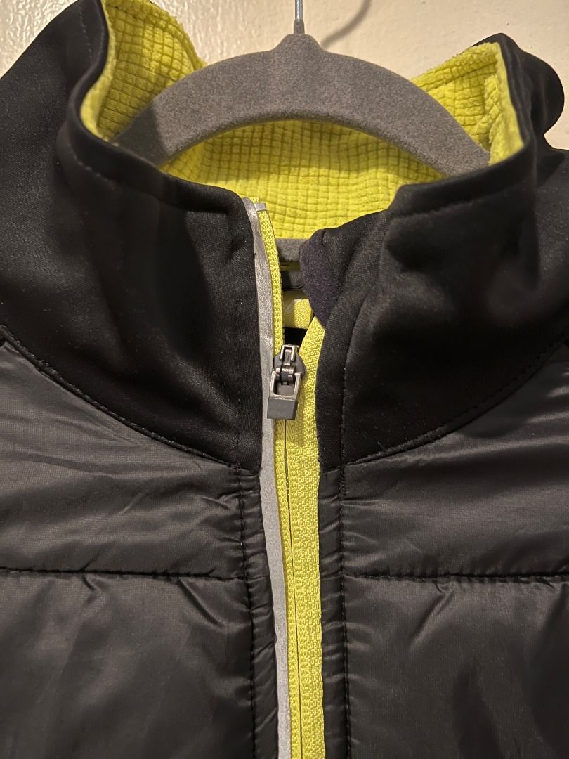 Crivit Black and Lime Green Running Jacket [j4] (Category: Activewear) located in Pasig City. Submitted by awesamfinds (Listing ID 1465839573, Image 2). Description: - Brand: Crivit - Color: Black with vibrant lime green accents - Design: Zip-up front with high collar - Material: Padded quilted torso panels with smooth sleeves and back - Pockets: Convenient zippered side pockets - Safety: Reflective strip detail on upper back for visibility - Con