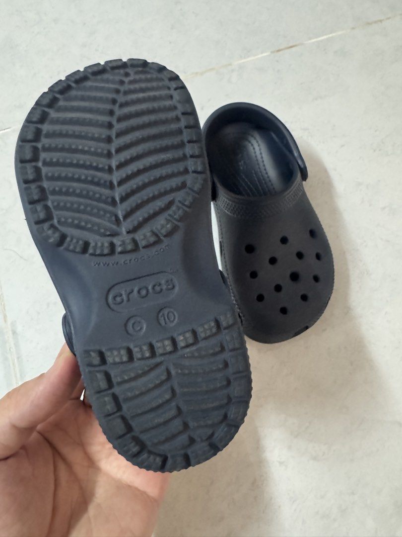 Crocs Classic Navy Blue Clogs Size 10 (Legit crocs) (Category: Babies & Kids Fashion) located in Binan City. Submitted by dupie_warren1982 (Listing ID 1465850278, Image 2). Description: - Color: Classic Navy Blue - Size: Toddlers US 10 (Stamped on sole) - Comfort: Iconic Crocs comfort footbed with ventilation holes for breathability - Fit: Secure pivoting heel straps with classic logo buttons - Condition: Great slip-on shoes for casual wear, walk