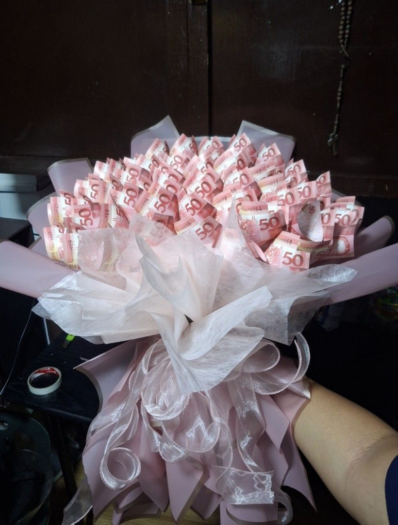 Custom Gift Bouquets Assorted Styles (Category: Flowers & Bouquets) located in Manila. Submitted by rhyannnnx (Listing ID 1465919018, Image 3). Description: - Handmade bouquets for birthdays, graduations, anniversaries, and more - Available designs: money bouquets, plushie arrangements, cosmetic sets, and artificial flowers - Beautifully wrapped in protective clear plastic with decorative ribbons - Comes in various colors and themes.