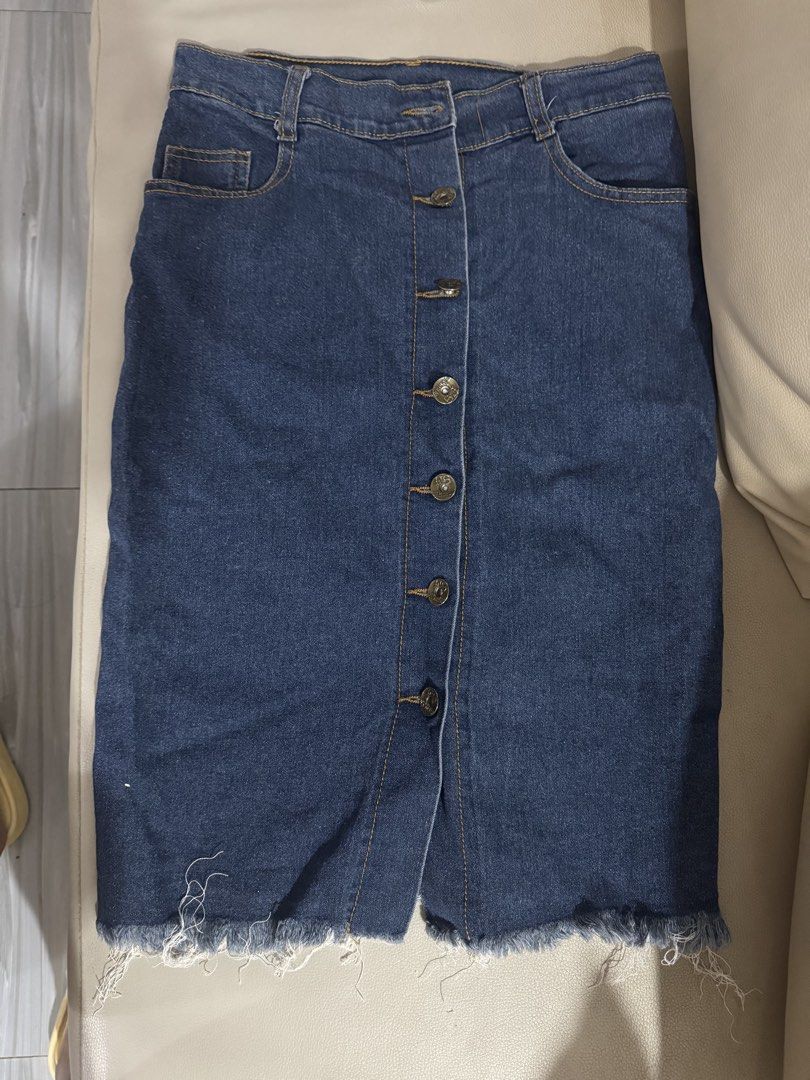 Dark Blue Denim Skirt with Button-Down Front and Raw Hem (Category: Skirts) located in Angeles City. Submitted by thala.1204.68 (Listing ID 1465805543, Image 1). Description: - Color: Dark blue denim Waist size -25-26 (stretchable) - Fit: Classic high-waisted cut - Details: Functional metal front buttons, side pockets, and trendy raw frayed hem - Length: Approx. 21 to 22 inches from waist to hem - Styling: Versatile piece that pairs easily with t