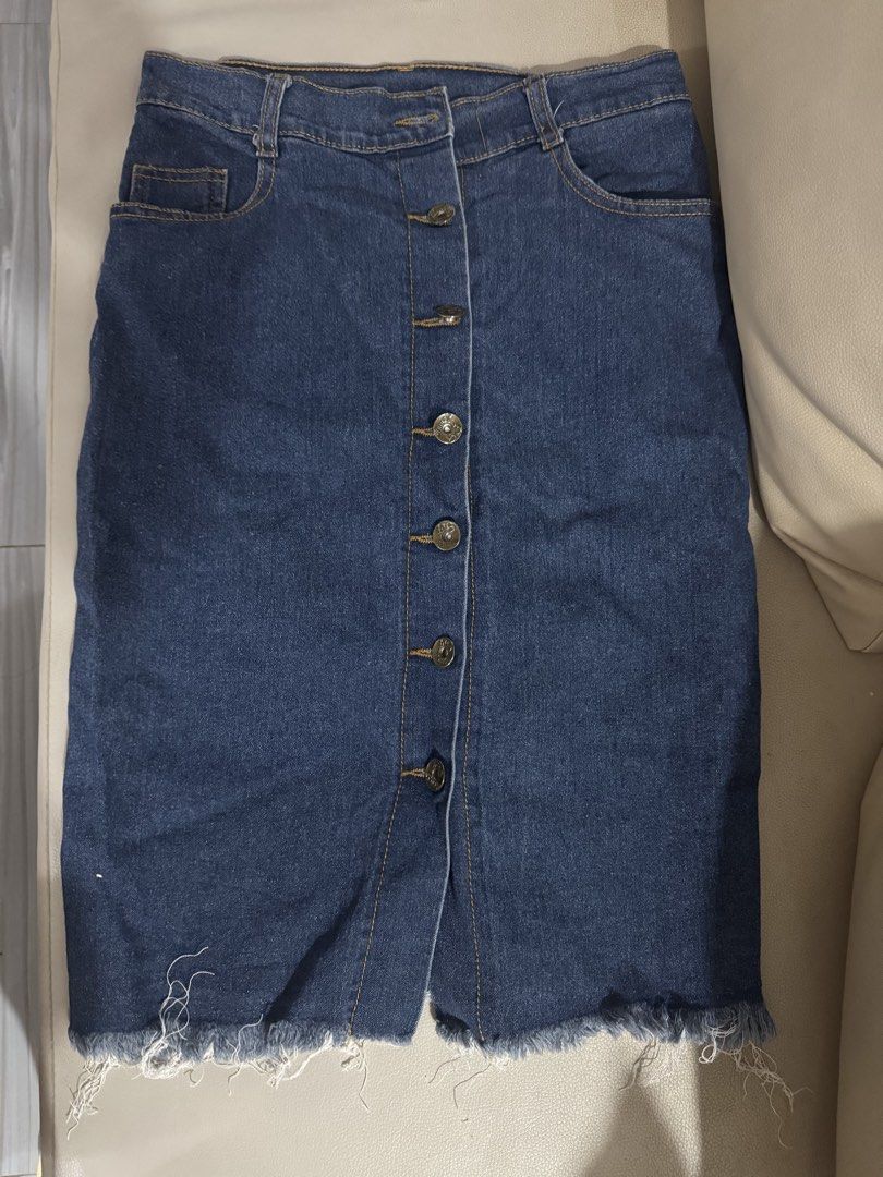 Dark Blue Denim Skirt with Button-Down Front and Raw Hem (Category: Skirts) located in Angeles City. Submitted by thala.1204.68 (Listing ID 1465805543, Image 3). Description: - Color: Dark blue denim Waist size -25-26 (stretchable) - Fit: Classic high-waisted cut - Details: Functional metal front buttons, side pockets, and trendy raw frayed hem - Length: Approx. 21 to 22 inches from waist to hem - Styling: Versatile piece that pairs easily with t