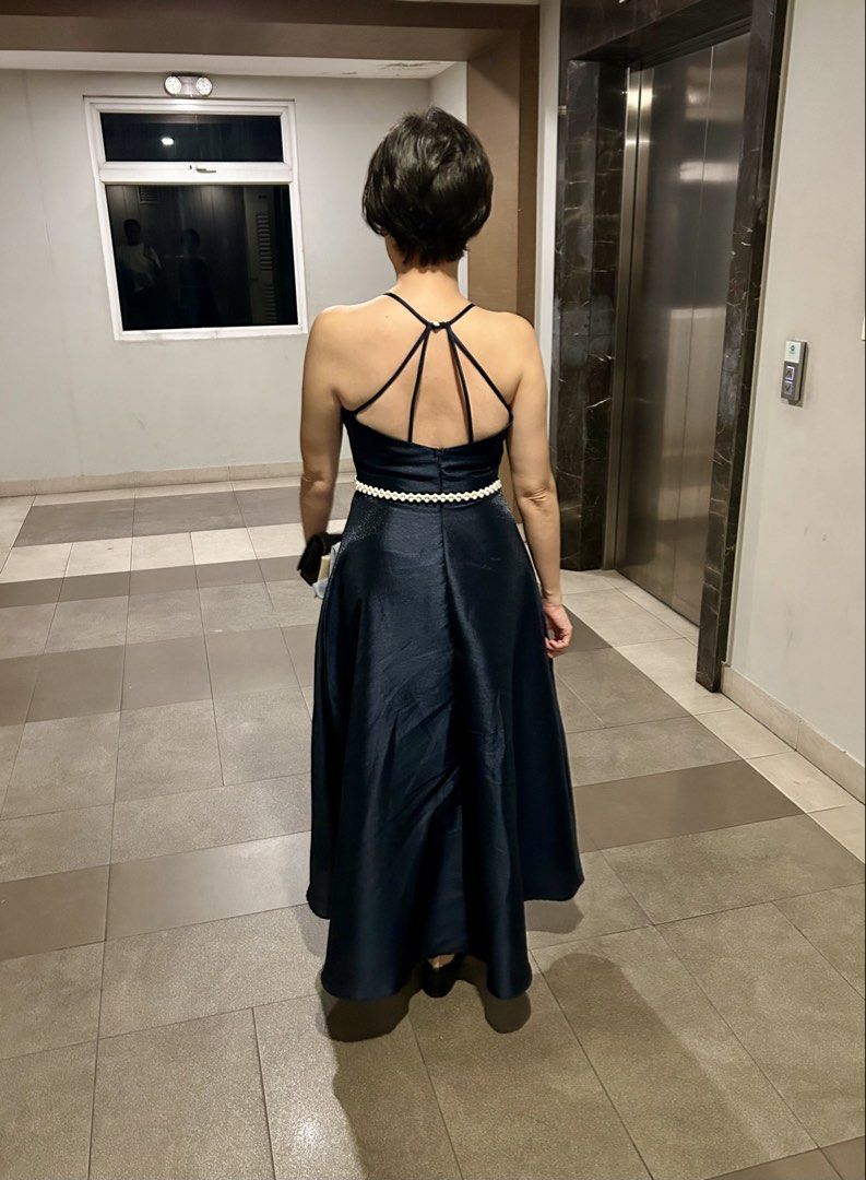 Dark blue halter neck midi dress (Category: Evening dresses & gowns) located in Manila. Submitted by raynebow (Listing ID 1465843720, Image 2). Description: - Color: Dark blue - Style: Halter neckline, fitted waist, and flared mid-calf skirt - Back details: Thin crisscross straps with a back zipper closure - Fabric: Smooth, slightly shiny material that holds its shape nicely - Condition: Worn only once for an event, still in excellent shape - Len