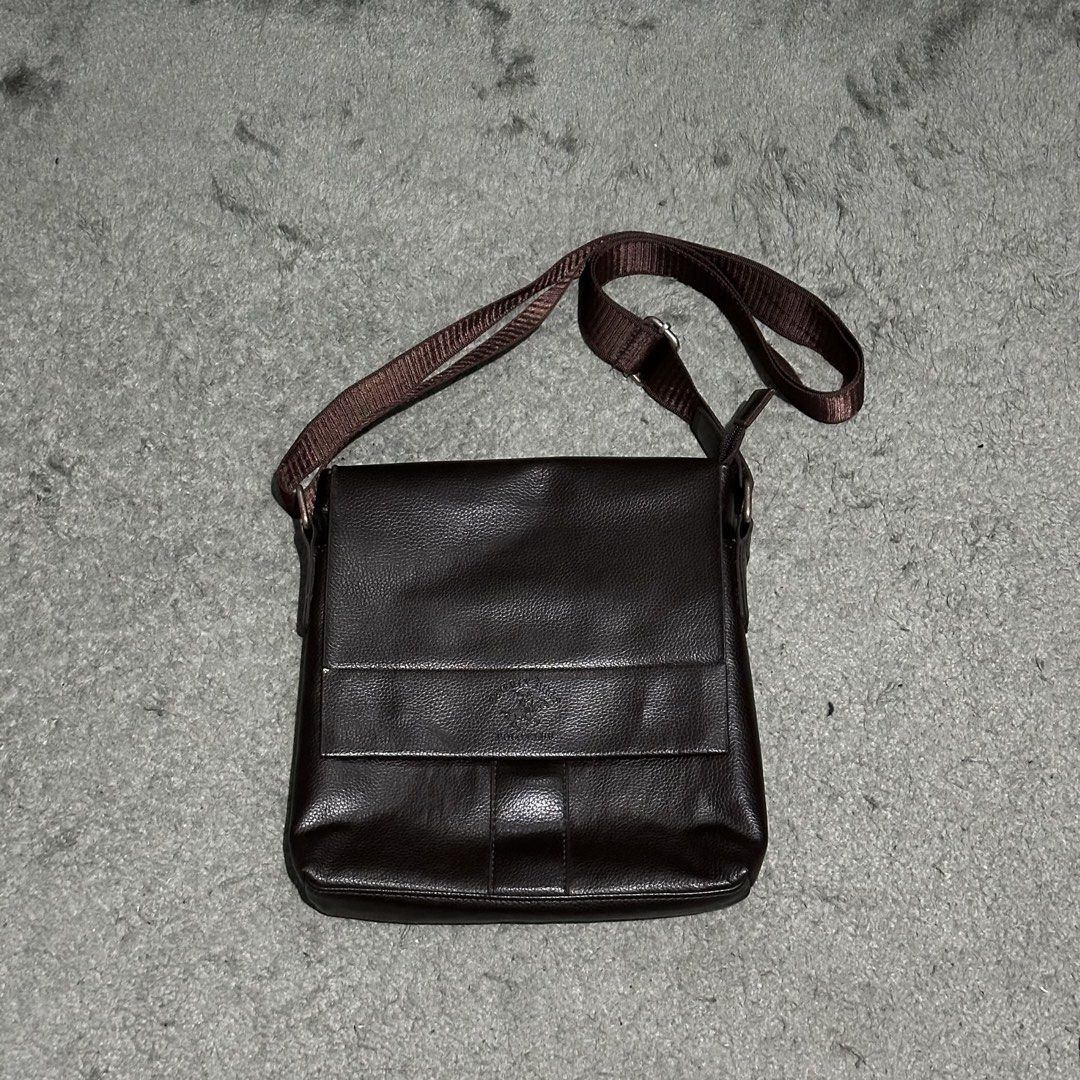 Dark Brown Leather Messenger Bag Crossbody (Category: Sling Bags) located in Lipa City. Submitted by jecoparra (Listing ID 1465843700, Image 1). Description: - Color: Dark brown - Material: Clean pebble texture faux leather - Closure: Flap closure - Strap: Adjustable brown fabric shoulder strap - Storage: Convenient exterior back zipper pocket + roomy main compartment for a tablet, wallet, and keys - Use: Perfect for daily commuting and casual us