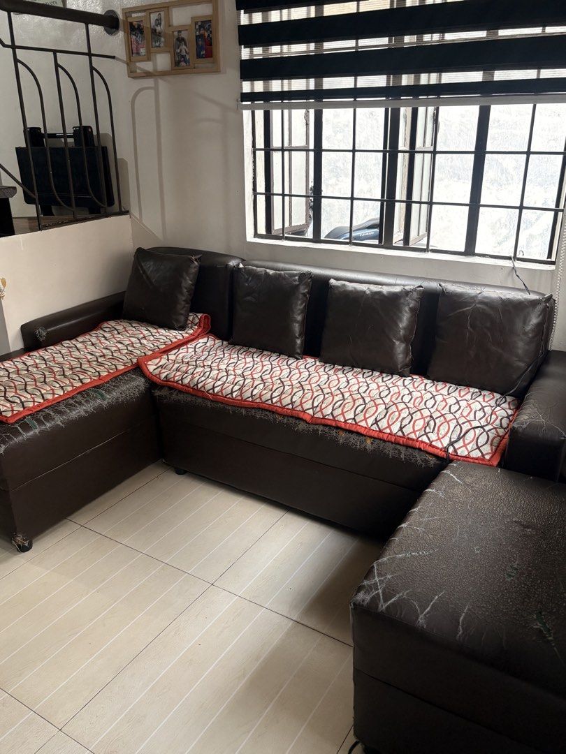 Dark Brown L-Shape Sectional Sofa with Cushions (Category: Sofas) located in Del Monte. Submitted by nicole.escurel (Listing ID 1465865462, Image 2). Description: - Dark brown leather sectional sofa with spacious seating capacity - Includes a comfortable chaise lounge section - Comes with a matching separate ottoman - Includes several matching dark brown toss pillows - Enhanced with cream and red patterned quilted seat covers - Flaw: Noticeable c