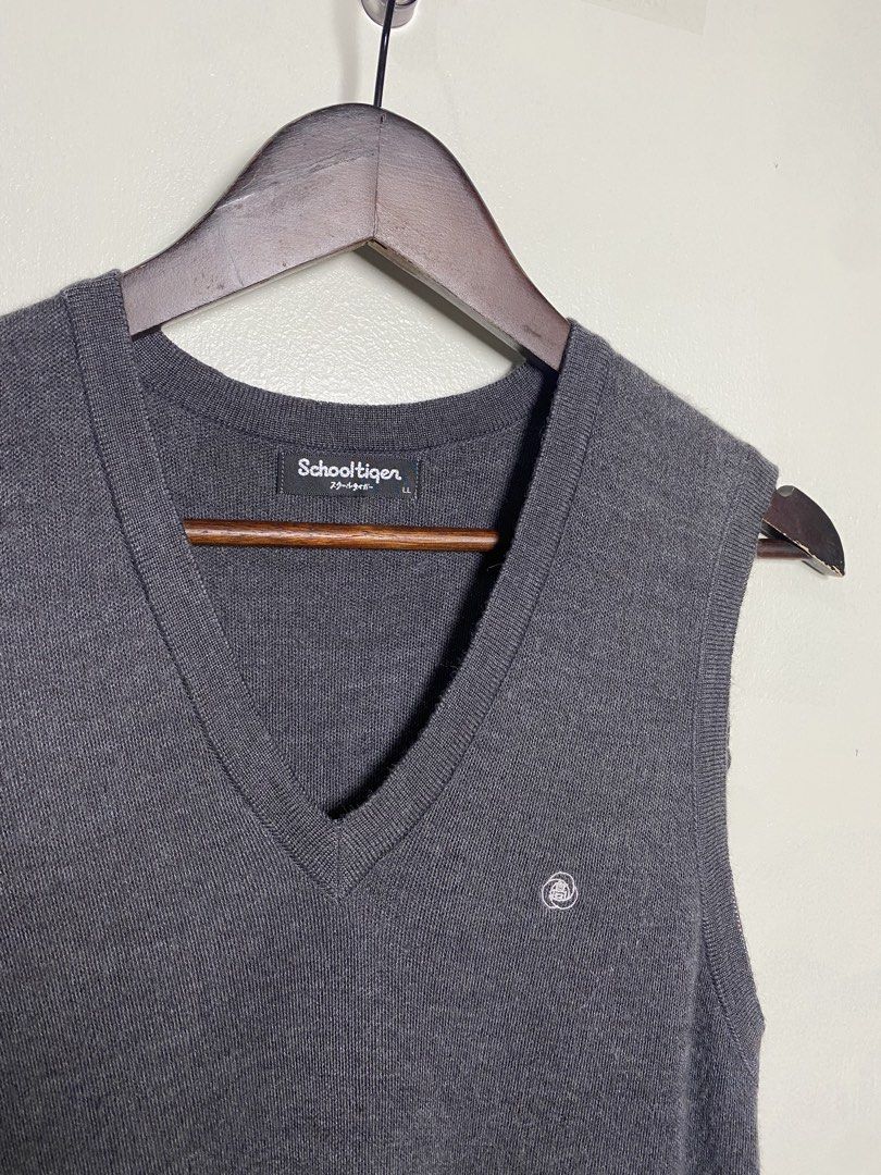 Dark gray v-neck knit vest (Category: Others Tops) located in Makati City. Submitted by indaysukaycloset (Listing ID 1465868064, Image 2). Description: DARK GRAY V-NECK KNIT VEST Brand: Schooltiger (Japan Brand) Size: LL on tag - Fits M-L Color: Dark Gray / Charcoal Details: - W-16.5 L-25 (laid flat, in inches) - V-neck sleeveless knit vest - Small embroidered logo on left chest - Ribbed hem & armhole - classic school / old money style - Material