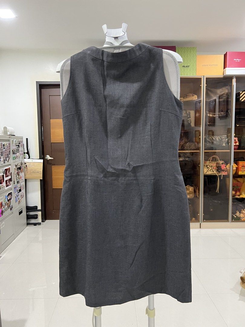 Dark Grey Sleeveless Work Dress (Category: Dresses) located in Manila. Submitted by imprincessg888 (Listing ID 1465854629, Image 1). Description: - Color: Dark grey - Design: Sleeveless, round neckline, textured fabric - Fit: Fitted waist seam with a straight skirt - Style: Clean look, simple and elegant cut - Versatility: Perfect for office wear or formal events - Easy Layering: Pairs effortlessly with blazers or jackets.