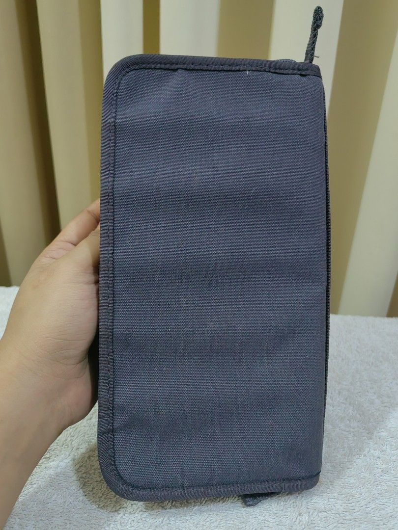 Dark Grey Travel Organizer Document Wallet (Category: Accessory Holder, Box & Organizers) located in Makati City. Submitted by prelovedtreatedwithlove (Listing ID 1465827482, Image 2). Description: - Color: Dark grey - Material: Durable canvas - Closure: Secure wrap-around zipper - Portability: Features a handy exterior carrying strap - Interior Organization: Multiple mesh slip pockets, card slots, and an attached key ring loop - Perfect For: Kee