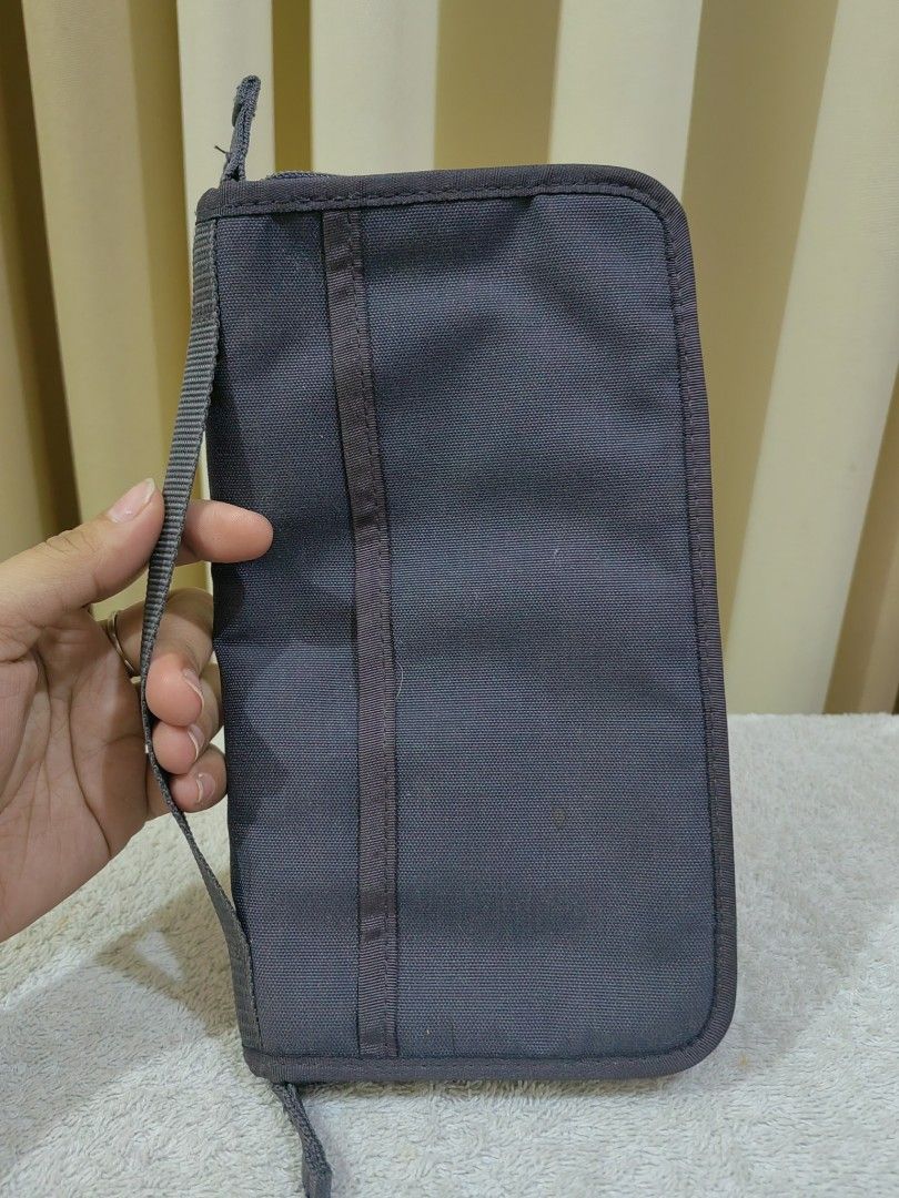 Dark Grey Travel Organizer Document Wallet (Category: Accessory Holder, Box & Organizers) located in Makati City. Submitted by prelovedtreatedwithlove (Listing ID 1465827482, Image 1). Description: - Color: Dark grey - Material: Durable canvas - Closure: Secure wrap-around zipper - Portability: Features a handy exterior carrying strap - Interior Organization: Multiple mesh slip pockets, card slots, and an attached key ring loop - Perfect For: Kee