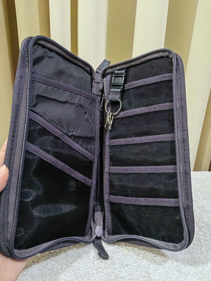 Dark Grey Travel Organizer Document Wallet (Category: Accessory Holder, Box & Organizers) located in Makati City. Submitted by prelovedtreatedwithlove (Listing ID 1465827482, Image 3). Description: - Color: Dark grey - Material: Durable canvas - Closure: Secure wrap-around zipper - Portability: Features a handy exterior carrying strap - Interior Organization: Multiple mesh slip pockets, card slots, and an attached key ring loop - Perfect For: Kee