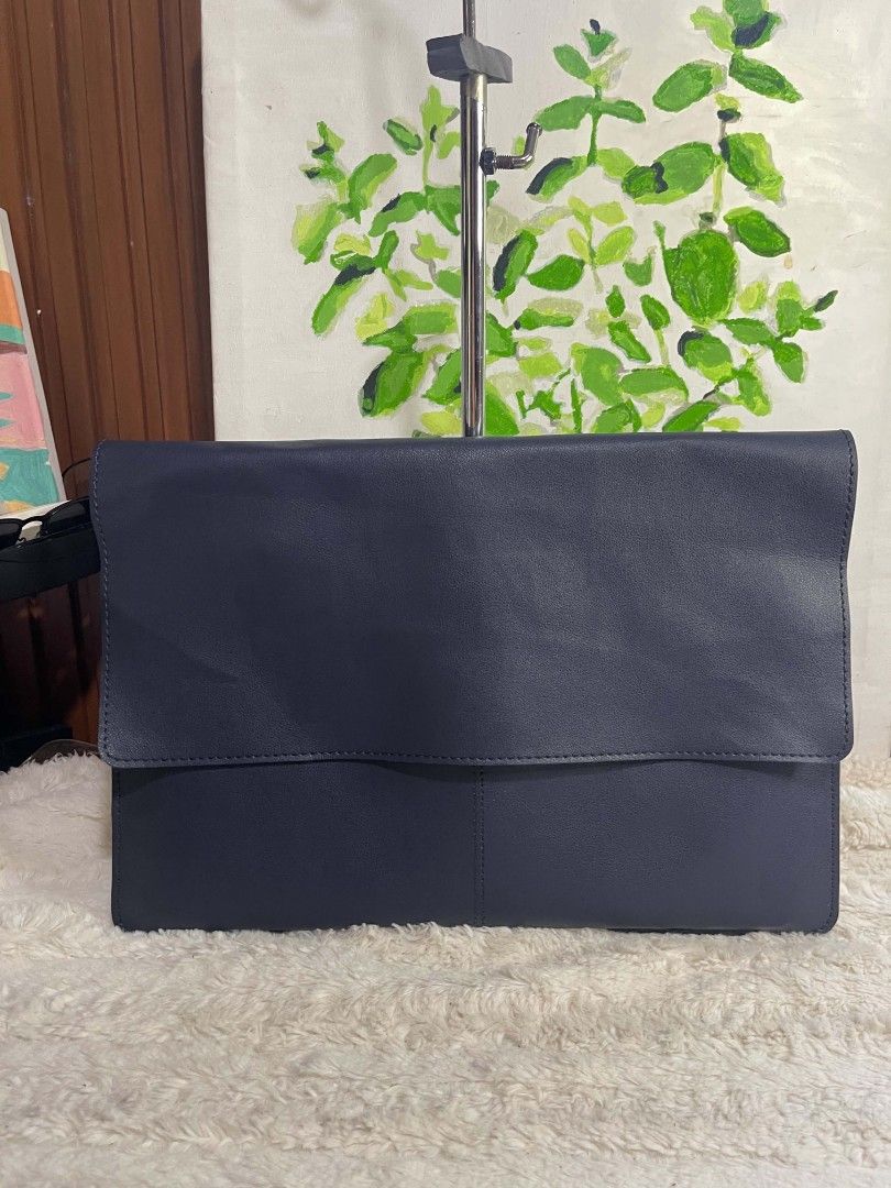 Dark Navy Blue Leather Envelope Laptop Sleeve Bag (Category: Laptop Bags & Sleeves) located in Naawan. Submitted by twilly.apparel2 (Listing ID 1465822172, Image 1). Description: - Color: Dark navy blue - Material: Premium leather with clean front stitching lines - Design: Minimalist envelope style with a secure large foldover flap - Protection: Soft interior compartment keeps your device safe from scratches - Portability: Slim and lightweight pr