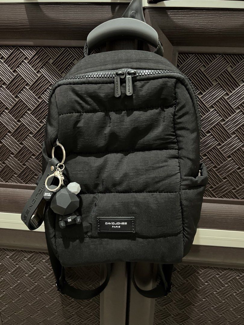 David Jones Paris Black Puffer Backpack with Keychain (Category: Backpacks) located in Cavite. Submitted by 24g.ph (Listing ID 1465870824, Image 1). Description: - Brand: David Jones Paris - Color/Style: Chic black quilted design - Closure & Straps: Secure chunky top zip with adjustable padded straps - Comfort: Breathable mesh backing for all-day wear - Storage: Roomy interior featuring a zipper pocket and side pockets - Extras: Includes an adora