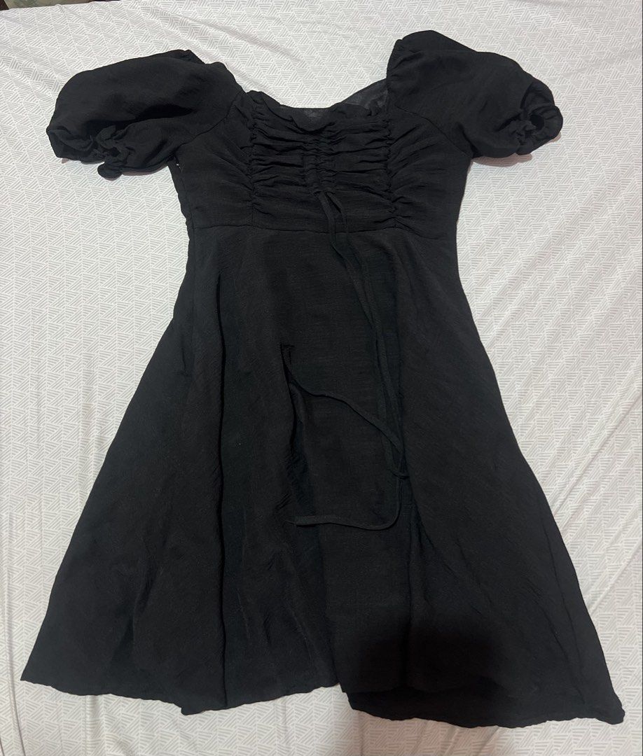 DAWAN Black Puff Sleeve Ruched Dress (Category: Dresses) located in Manila. Submitted by kaceylgt (Listing ID 1465925420, Image 1). Description: - Brand: Dawan - Color: Black - Style: Mini dress with flare skirt and fitted bodice - Details: Puff sleeves and ruched front with tie string - Condition: Clean fabric, tag attached near neckline - Versatility: Great for casual wear or a night out.