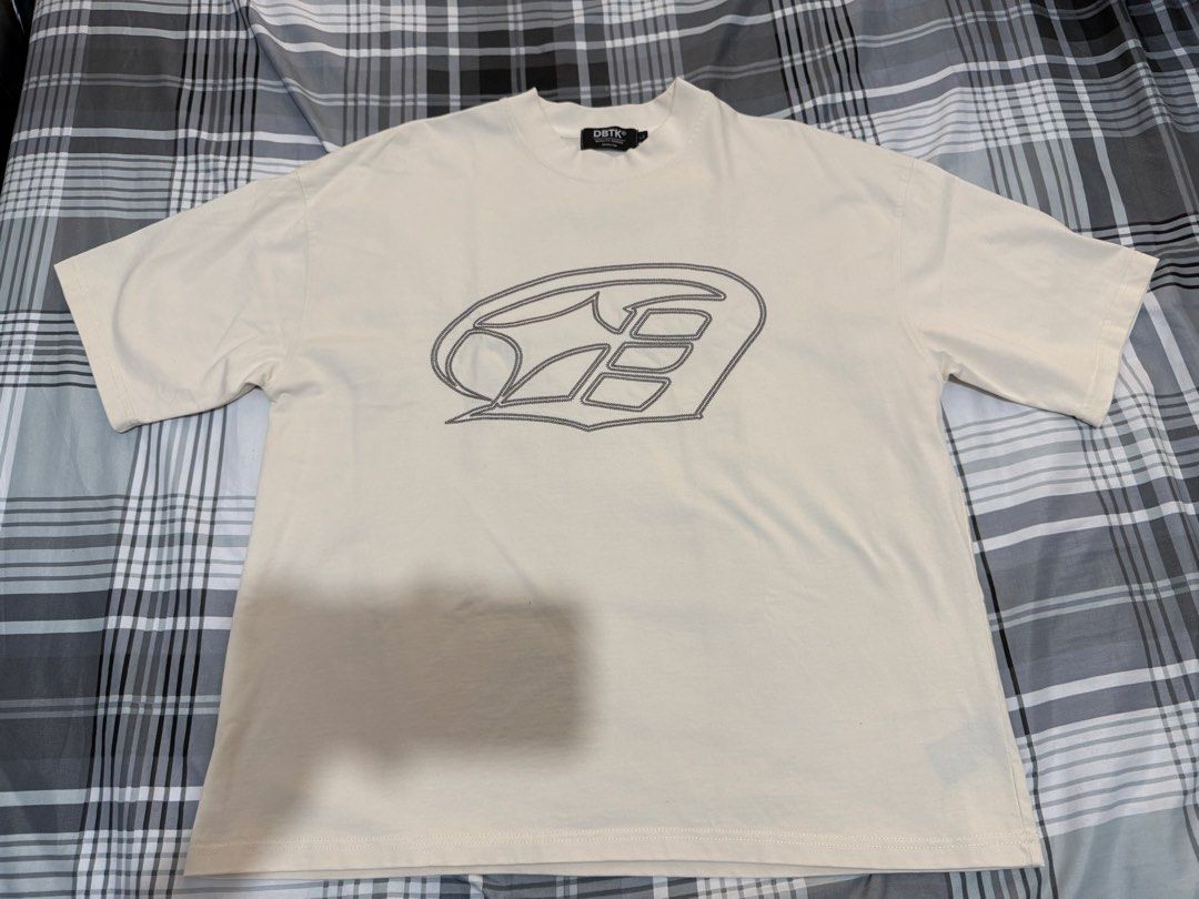 DBTK Evermore Atlas Graphic Tee Cream (Category: Tshirts & Polo Shirts ) located in Pasig City. Submitted by rchsh (Listing ID 1465847673, Image 1). Description: - Brand: DBTK (Evermore Collection) - Color: Cream - Design: Small embroidered chest logo, large Atlas graphic on the back - Fit: Short sleeves, relaxed boxy fit - Details: Woven label on the bottom hem - Condition: 10/10, clean fabric with no flaws and intact graphics.