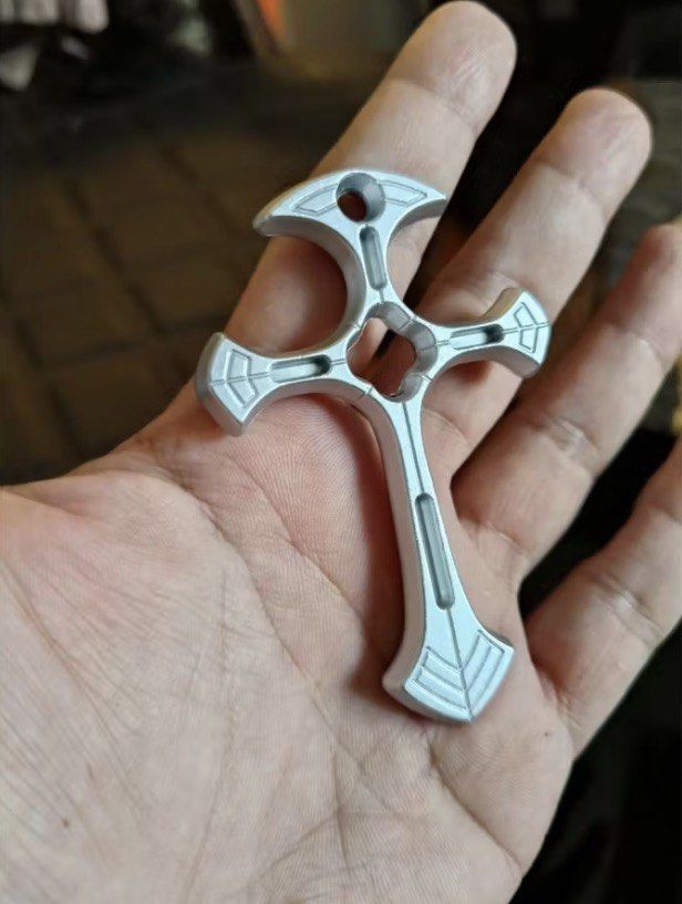 Decorative Cross Shape Mount For Bicycle Frame (Category: Bicycles) located in Quezon City. Submitted by liana.finds (Listing ID 1465797228, Image 2). Description: - Material: Solid metal with machined detailing - Placement: Mounts near rear disc brake and kickstand - Style: Adds a custom, edgy look to your bike - Installation: Uses existing bike frame bolts for easy setup - Compatibility: Fits standard bicycle frames with rear mount areas.