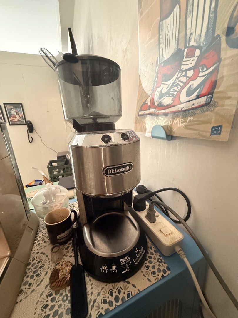 DeLonghi Dedica Coffee Grinder (Category: Coffee Machines & Makers) located in Mandaluyong City. Submitted by ohayouclub (Listing ID 1465840843, Image 1). Description: - Model: DeLonghi Dedica Digital Coffee Grinder - Finish: Sleek stainless steel with clear bean hopper - Display: Blue digital screen for grind settings, cup amounts, and strength options - Versatility: Adjustable dial ranging from fine espresso to coarse French press - Condition: 