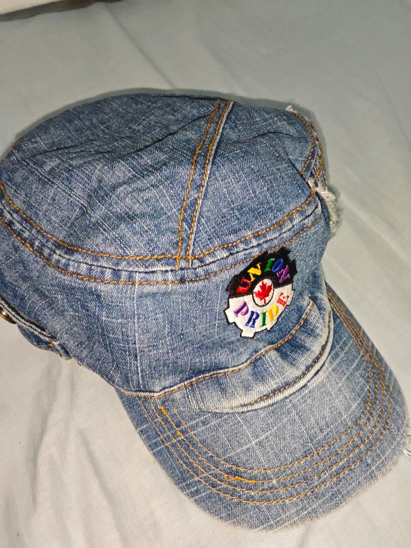 Denim Hat with Union Pride Patch (Category: Hats & Beanies) located in Quezon. Submitted by strawberry_me (Listing ID 1465796418, Image 1). Description: - Style: Streetwear blue denim cap - Details: Contrast yellow stitching and side button accent - Finish: Distressed, frayed edges on the visor and crown - Design: Colorful 'Union Pride' patch with a red maple leaf center - Fit: Unisex, great for everyday casual outfits - Condition: Brand new / Ex