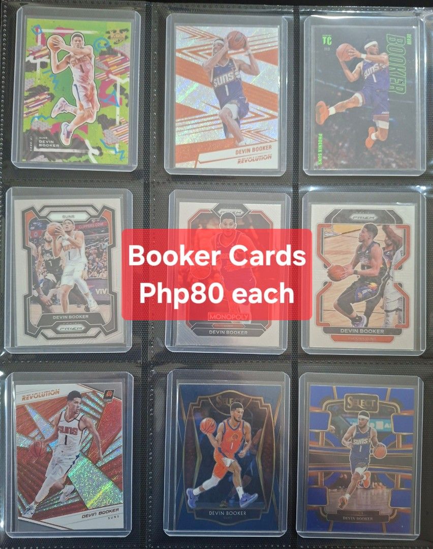 Devin Booker Phoenix Suns Basketball Cards Lot (Category: Raw Singles) located in Taytay. Submitted by bouncy_bee (Listing ID 1455733213, Image 1). Description: - Lot of Devin Booker basketball cards - Features various sets like Contenders, Prizm, Select, Revolution, and more - Ideal for any Phoenix Suns fan or collector - All cards are kept in protective sleeves - Please check the photos to see the specific cards included.
