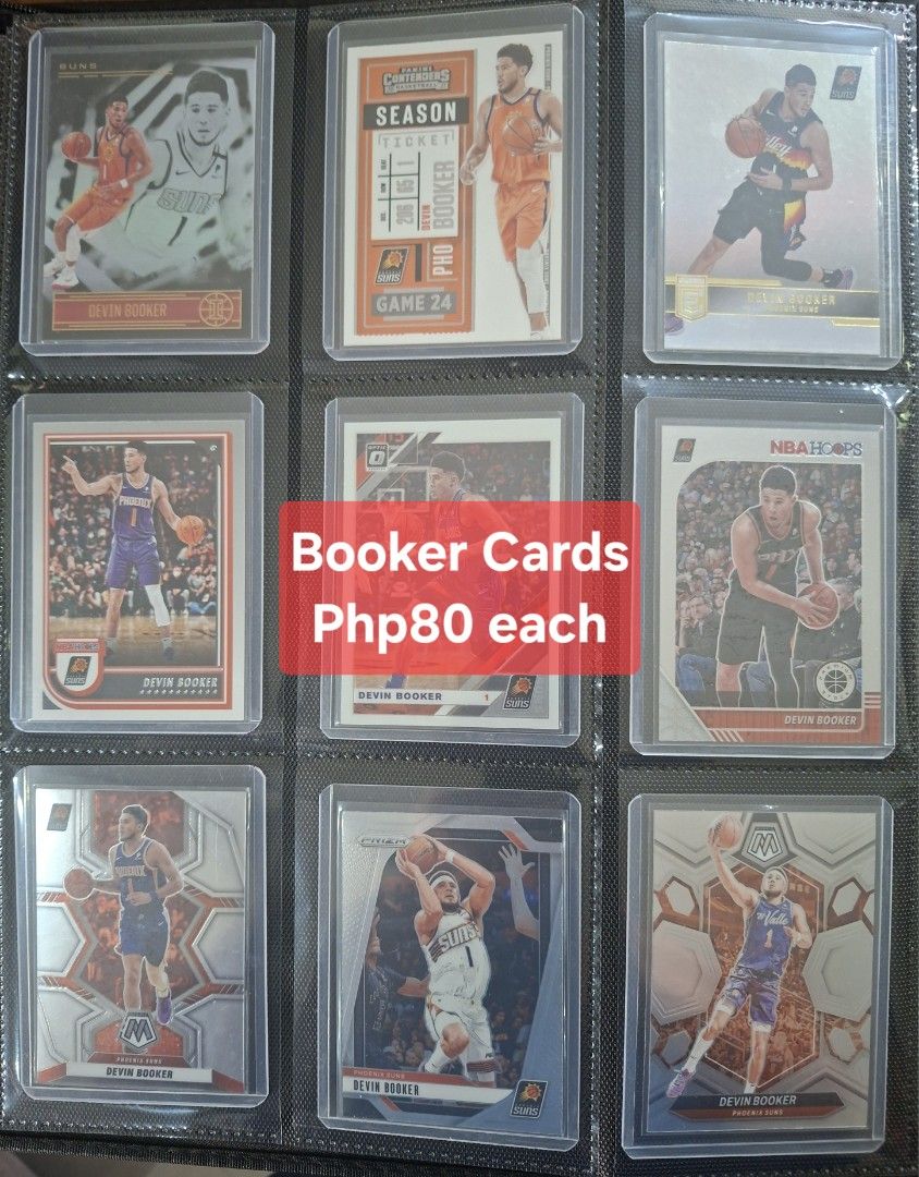 Devin Booker Phoenix Suns Basketball Cards Lot (Category: Raw Singles) located in Taytay. Submitted by bouncy_bee (Listing ID 1455733213, Image 2). Description: - Lot of Devin Booker basketball cards - Features various sets like Contenders, Prizm, Select, Revolution, and more - Ideal for any Phoenix Suns fan or collector - All cards are kept in protective sleeves - Please check the photos to see the specific cards included.