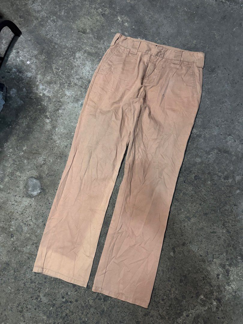 Dickies Khaki Work Pants Chinos (Category: Chinos) located in Pasig City. Submitted by dripthrift1600 (Listing ID 1465949622, Image 1). Description: - Brand: Dickies - Color: Khaki Tan - Fit: Classic straight leg - Details: Sturdy belt loops, rear welt pockets, iconic logo tag on back pocket - Condition: Stains and wear marks throughout for an authentic worn-in look - Style: Ideal everyday skate pants or reliable workwear staple - Dimes: 32x42x8.