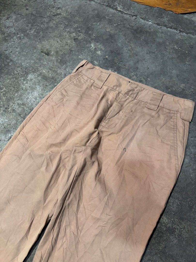 Dickies Khaki Work Pants Chinos (Category: Chinos) located in Pasig City. Submitted by dripthrift1600 (Listing ID 1465949622, Image 3). Description: - Brand: Dickies - Color: Khaki Tan - Fit: Classic straight leg - Details: Sturdy belt loops, rear welt pockets, iconic logo tag on back pocket - Condition: Stains and wear marks throughout for an authentic worn-in look - Style: Ideal everyday skate pants or reliable workwear staple - Dimes: 32x42x8.