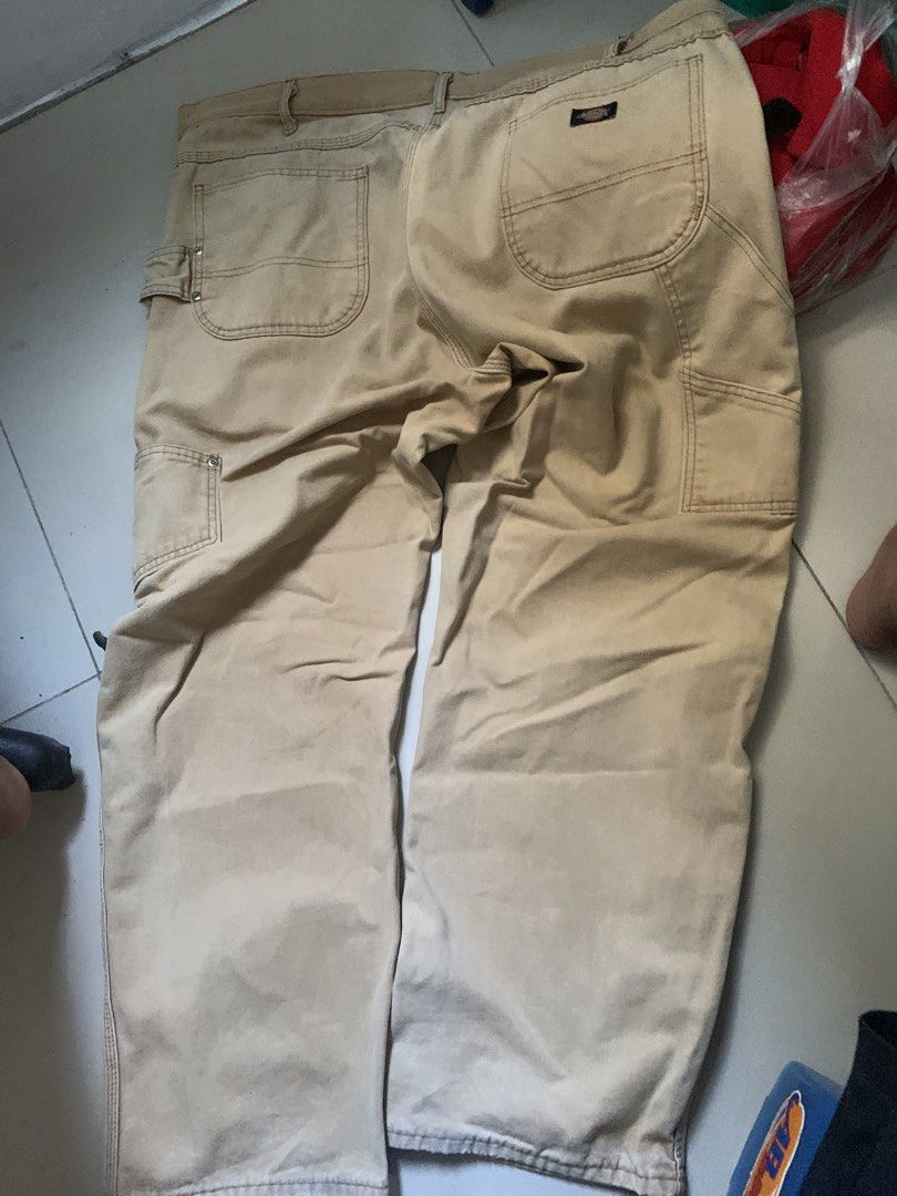 Dickies Men's Khaki Cargo Work Pants (Category: Trousers) located in Batac City. Submitted by egorospe (Listing ID 1465796837, Image 2). Description: - Brand: Dickies - Color: Khaki - Material: Heavy-duty canvas fabric - Fit: Relaxed fit through the legs - Features: Utility pockets on the sides, left leg hammer loop, and multiple back pockets with Dickies logo patch - Condition: Excellent / Pre-loved - Style: Ideal for job sites, manual work, or 