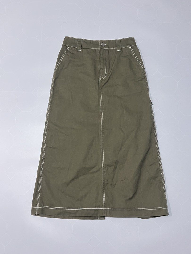 Dickies Olive Green Cargo Midi Skirt (Category: Skirts) located in Caloocan City. Submitted by lostarchive_55 (Listing ID 1465916178, Image 3). Description: - Brand: Dickies - Item: Utility midi skirt in olive green - Material: Heavy-duty cotton twill with contrast white stitching - Fit: High-waisted with belt loops, zip fly, and button closure - Details: Multiple side/back utility pockets, hammer loop, and front hem slit - Branding: Iconic Dicki
