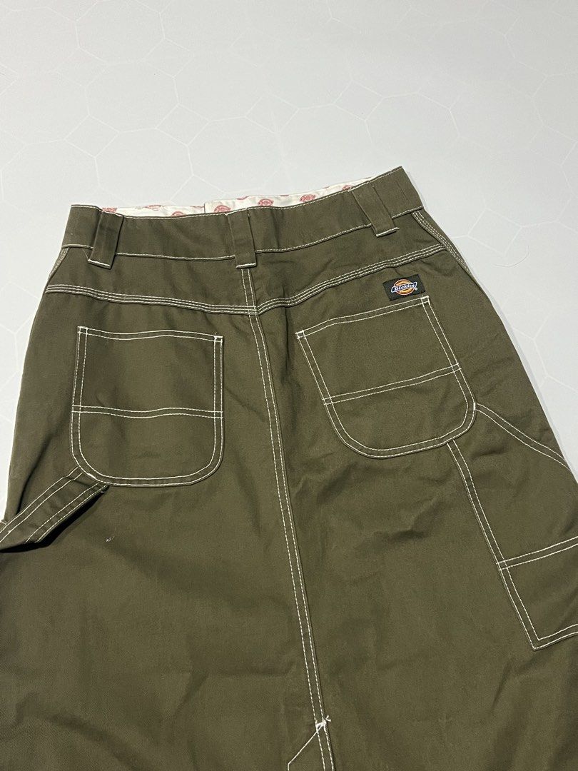 Dickies Olive Green Cargo Midi Skirt (Category: Skirts) located in Caloocan City. Submitted by lostarchive_55 (Listing ID 1465916178, Image 2). Description: - Brand: Dickies - Item: Utility midi skirt in olive green - Material: Heavy-duty cotton twill with contrast white stitching - Fit: High-waisted with belt loops, zip fly, and button closure - Details: Multiple side/back utility pockets, hammer loop, and front hem slit - Branding: Iconic Dicki