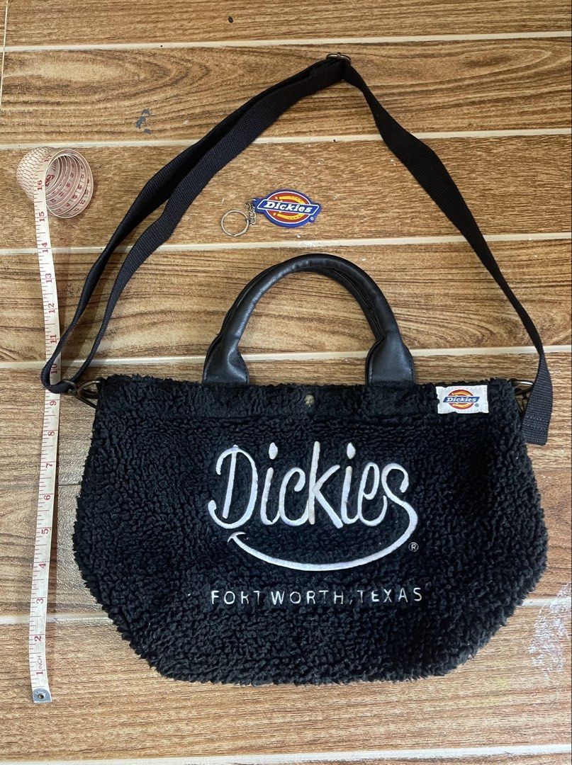 Dickies Sherpa Tote Bag with Removable Strap (Black) (Category: Tote Bags) located in Batangas. Submitted by michaelyfc01588 (Listing ID 1465770547, Image 1). Description: Black fuzzy sherpa tote bag from Dickies, Fort Worth Texas. Leatherette grab handles and removable black adjustable shoulder strap. Magnetic snap closure at the top. White brand label sewn on the side, plus large white embroidered lettering across the front. Fluffy exterior tex