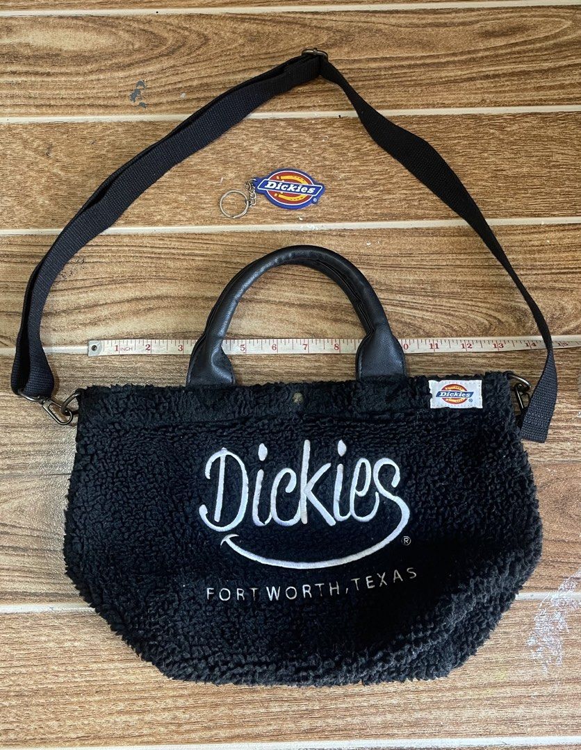 Dickies Sherpa Tote Bag with Removable Strap (Black) (Category: Tote Bags) located in Batangas. Submitted by michaelyfc01588 (Listing ID 1465770547, Image 2). Description: Black fuzzy sherpa tote bag from Dickies, Fort Worth Texas. Leatherette grab handles and removable black adjustable shoulder strap. Magnetic snap closure at the top. White brand label sewn on the side, plus large white embroidered lettering across the front. Fluffy exterior tex