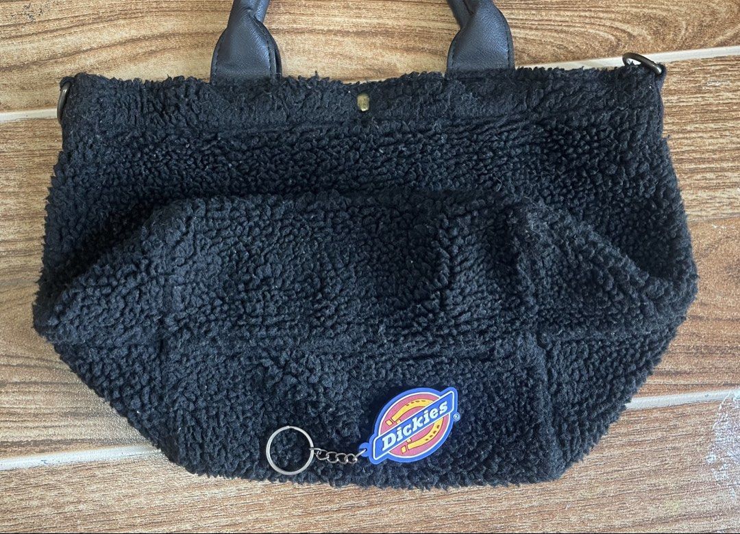 Dickies Sherpa Tote Bag with Removable Strap (Black) (Category: Tote Bags) located in Batangas. Submitted by michaelyfc01588 (Listing ID 1465770547, Image 3). Description: Black fuzzy sherpa tote bag from Dickies, Fort Worth Texas. Leatherette grab handles and removable black adjustable shoulder strap. Magnetic snap closure at the top. White brand label sewn on the side, plus large white embroidered lettering across the front. Fluffy exterior tex