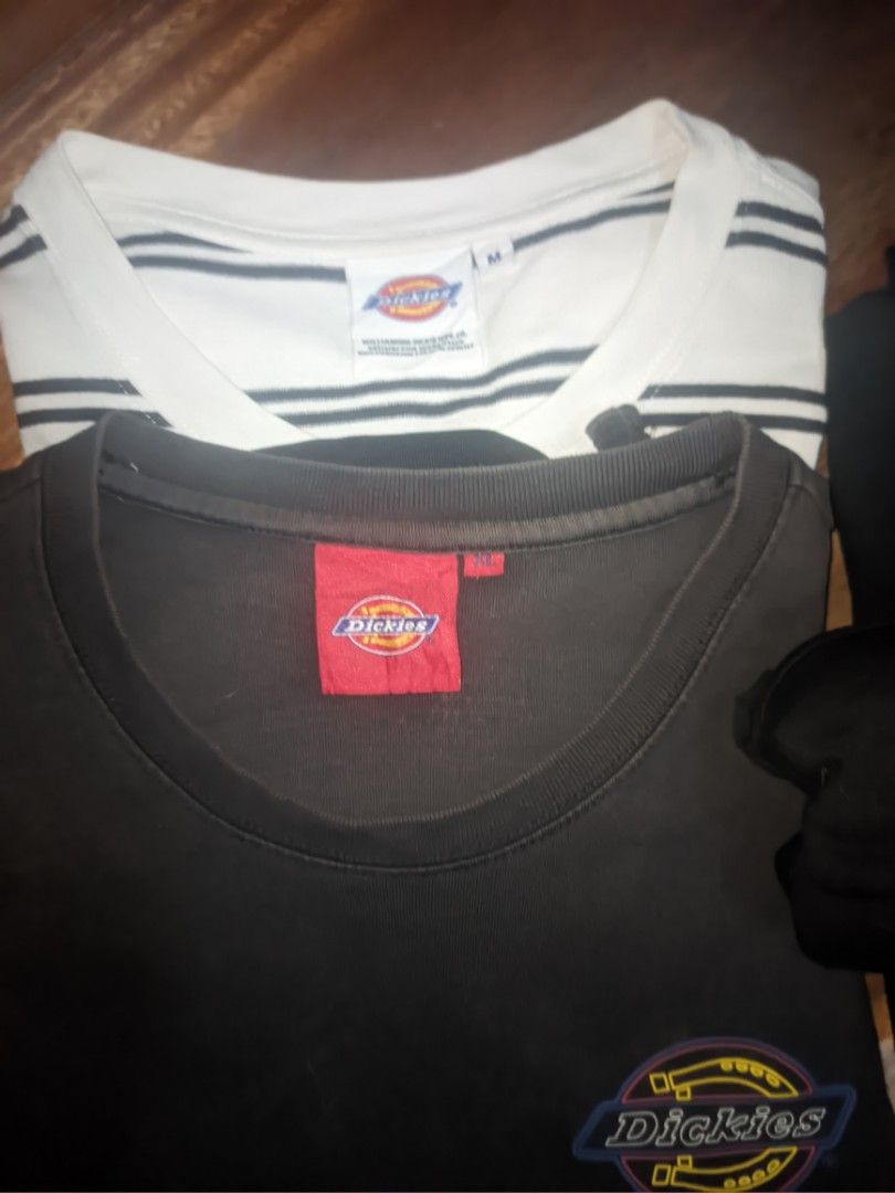 Dickies T-Shirt Bundle (Size M and XL) (Category: Tshirts & Polo Shirts ) located in Manila. Submitted by younghustler_25 (Listing ID 1465803267, Image 1). Description: - Brand: Dickies - Quantity: Bundle of 2 t-shirts - White Striped Shirt: Size M - Solid Black Shirt: Size XL with horseshoe graphic logo near the hem - Details: Classic woven neck labels - Material: Comfortable, breathable cotton - Style: Easy to pair with any casual outfit.