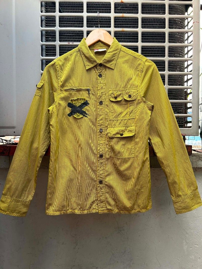 Y2K Diesel Utility Longsleeve Shirt (Category: Longsleeves) located in Manila. Submitted by zerowastethriftco. (Listing ID 1465934085, Image 1). Description: -As New Condition -Size L on Tag -Dimes L25xW17 -No Issue -This is a vintage Diesel long-sleeve utility work shirt/jacket in a distinctive mustard yellow hue with thin vertical stripes. -Authentic pieces from this specific Diesel era are highly sought after now due to the massive resurgence 