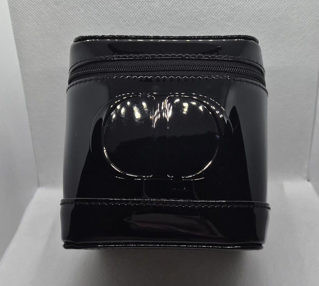 Dior Beauty Black Patent Vanity Case (Category: Luxury Bags & Wallets) located in Manila. Submitted by prelovedbyc.hannah (Listing ID 1465879317, Image 1). Description: - Authentic Dior Beauty cosmetic case - Sleek black patent finish with iconic embossed CD logo - Structured box shape equipped with a convenient top handle - Secure zip-around top opening - Spacious interior lined in black fabric with repeated CD monograms and official tag - Perfe