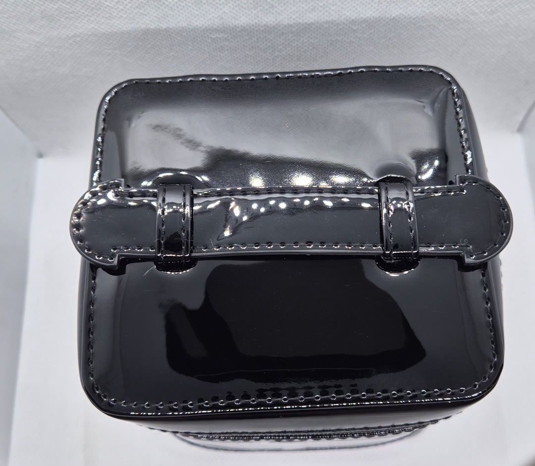 Dior Beauty Black Patent Vanity Case (Category: Luxury Bags & Wallets) located in Manila. Submitted by prelovedbyc.hannah (Listing ID 1465879317, Image 2). Description: - Authentic Dior Beauty cosmetic case - Sleek black patent finish with iconic embossed CD logo - Structured box shape equipped with a convenient top handle - Secure zip-around top opening - Spacious interior lined in black fabric with repeated CD monograms and official tag - Perfe