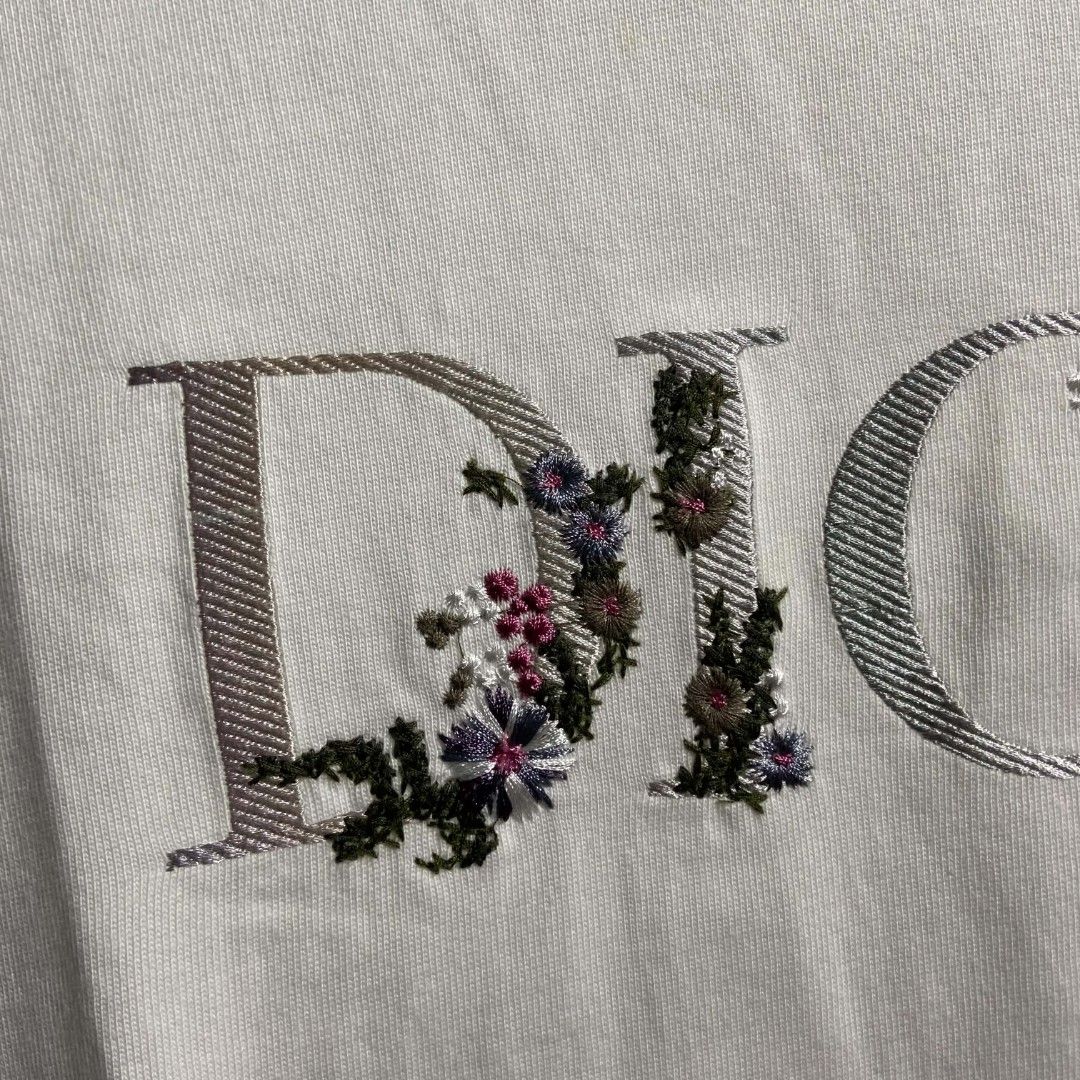 Dior Flower (Category: Luxury Apparel) located in Manila. Submitted by lumang__gamit00 (Listing ID 1465802629, Image 2). Description: The white cotton tee features a distinctive "DIOR" chest logo filled with colorful floral embroidery 20-29 no issue.