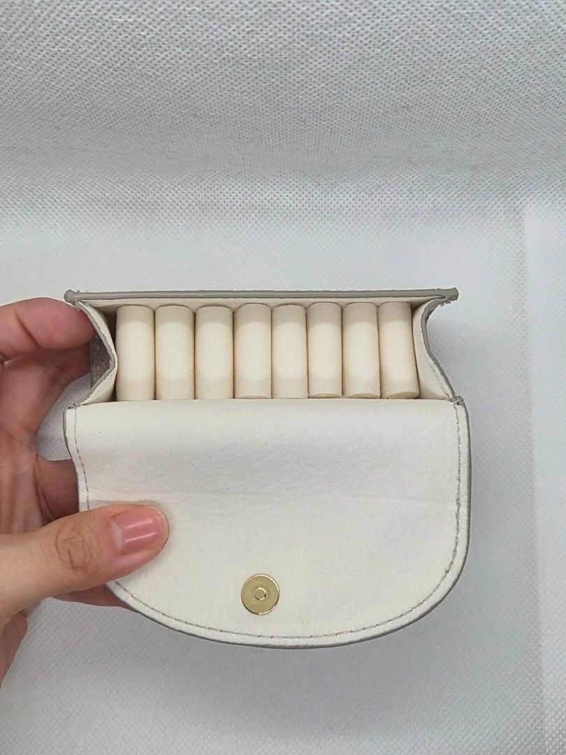 Dior Grey Fabric Jewelry Case (Category: Accessory Holder, Box & Organizers) located in Manila. Submitted by prelovedbyc.hannah (Listing ID 1465849509, Image 2). Description: - Brand: Dior - Material: Grey textured fabric with clean white interior lining - Accents: Signature gold Dior logo on front flap - Closure: Secure magnetic snap - Storage: Padded rolls designed to hold multiple rings securely - Size: Approximately 12 cm long - Condition: Ex