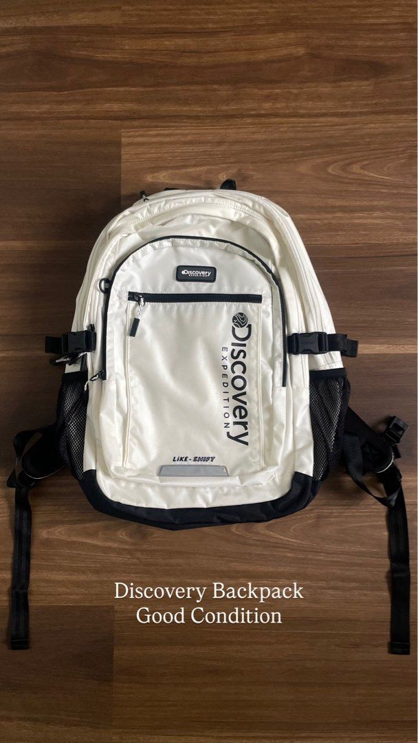 Discovery Expedition Like-Shift White Black Backpack (Category: Backpacks) located in Bacolod City. Submitted by jmcercado (Listing ID 1465925906, Image 1). Description: - Brand: Discovery Expedition - Color: White and black - Design: Bold vertical logo on front pocket with reflective strip detail near the base - Storage: Zippered main and front compartments, plus convenient side mesh water bottle pockets - Comfort & Fit: Adjustable shoulder stra