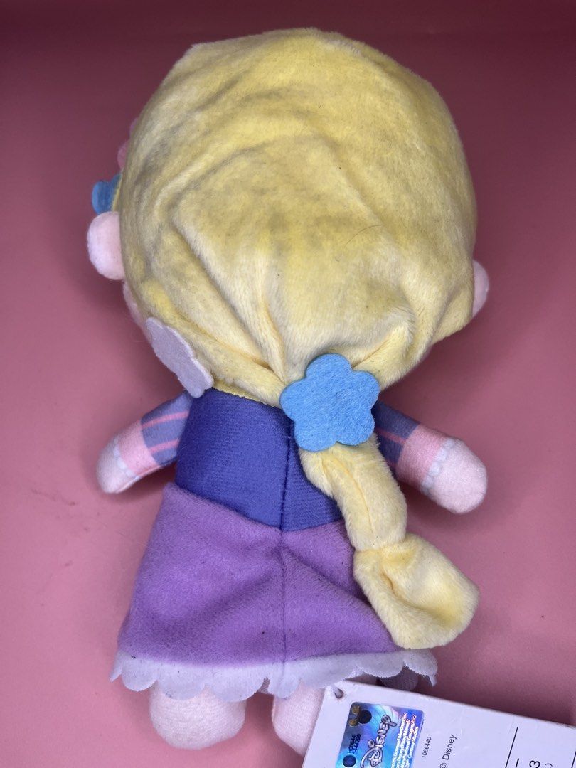 Disney Rapunzel SEGA Plush Toy (Category: Plushies & Soft Toys) located in Caloocan City. Submitted by snapshop_ph (Listing ID 1465801633, Image 3). Description: Rapunzel plush from Sega with Disney hologram tag. Blonde hair styled in a braid with felt flower hair clips. Purple dress with pink ribbon details on the bodice and a white ruffled hem. Stands about handheld size. Original tag attached at the bottom..