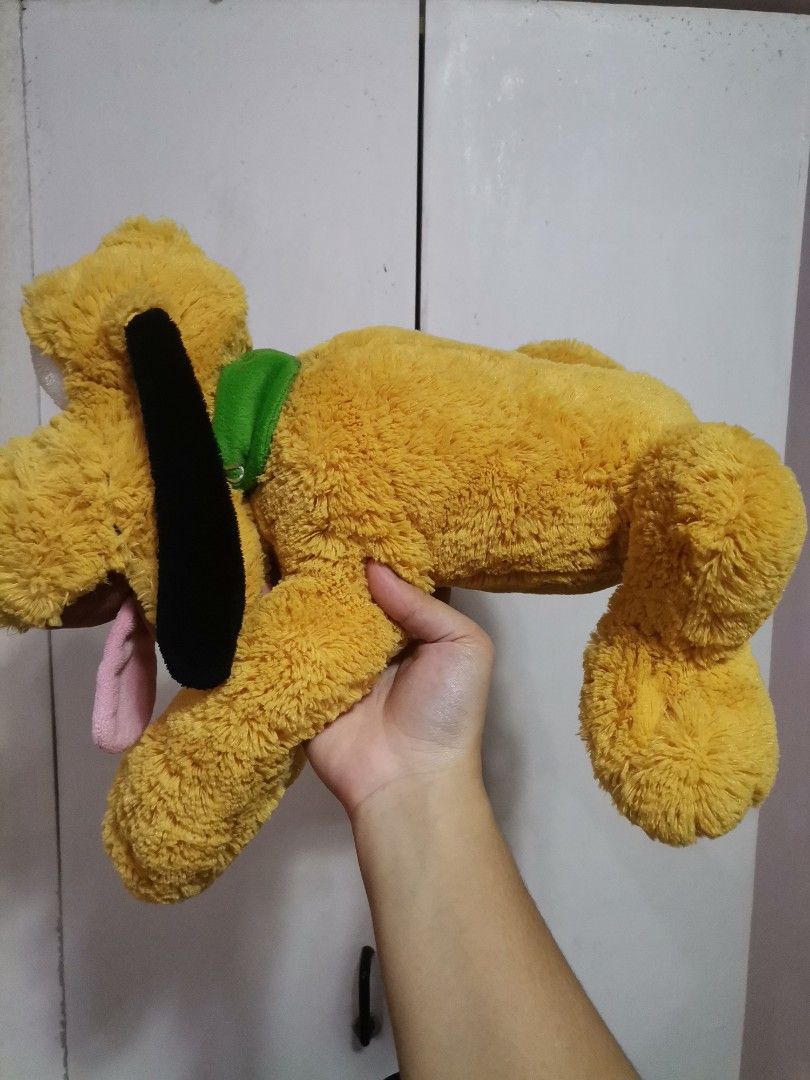 Disney Store Pluto Plush Toy with Green Collar (Category: Plushies & Soft Toys) located in Makati City. Submitted by kookybearsstuff (Listing ID 1465888416, Image 2). Description: - Authentic Disney Store Pluto plush toy - Features iconic yellow body, black floppy ears, and green collar - Playful design with tongue sticking out - Original Pasadena, CA tag still attached - Perfect gift for Disney fans and collectors - Ships securely from a trusted