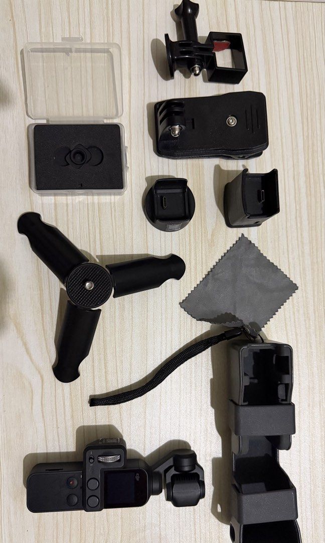 DJI Osmo Pocket 1 with Controller Wheel and Wireless Module (Category: Cameras) located in Taguig. Submitted by aymjeyarbi (Listing ID 1465803976, Image 1). Description: Complete DJI Osmo Pocket 1 vlogging bundle: - DJI controller wheel module and wireless charging base module included - TinyRigs protective case - Standee & charging tripod - Mini tripod - Wide-angle lens - 360 Backpack clip.