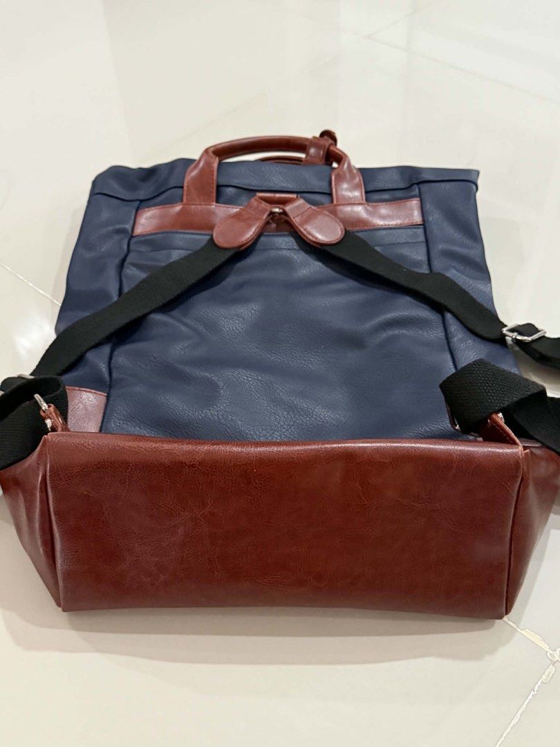 d.kelly 1985 Navy and Brown Backpack (Category: Backpacks) located in Cabuyao City. Submitted by seokjinspree (Listing ID 1465761895, Image 3). Description: Brand: D.Kelly 1985 Color: Navy blue with stylish brown faux leather trim Carry Options: Dual top carry handles and adjustable black shoulder straps Storage: Front zipper pocket and a spacious main compartment Details: Metallic brand plaque and embossed lettering on the lower front.