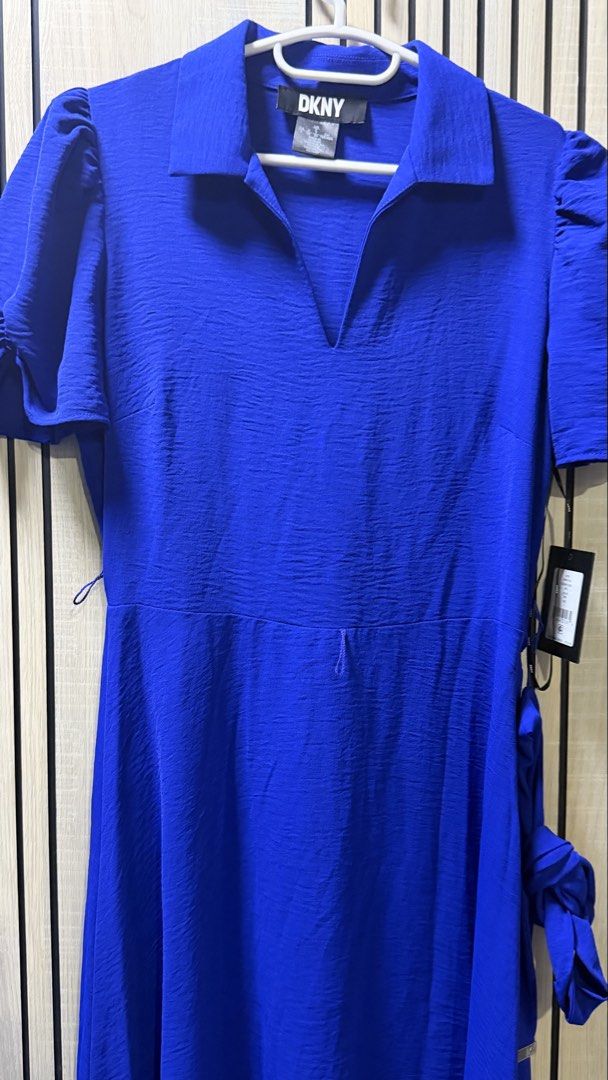 DKNY Midi Dress (Category: Dresses) located in Muntinlupa City. Submitted by avampaya (Listing ID 1465909375, Image 2). Description: DKNY dress in iris blue. Collared V-neckline with short puff sleeves. Fitted waist with a tie belt detail on the side. Flowy midi length skirt. .