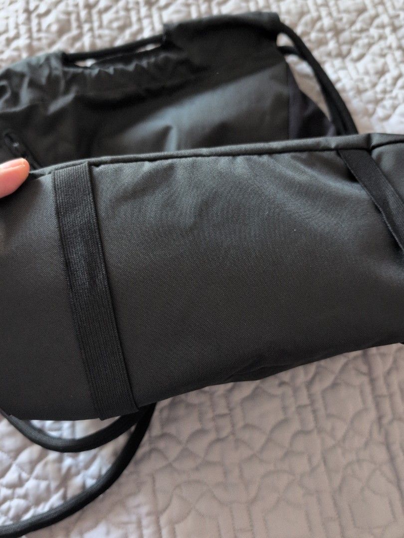 Domyos Drawstring Bag 15L (Category: Backpacks) located in Makati City. Submitted by g.jo.h (Listing ID 1465953155, Image 3). Description: used 2x only - Brand: Domyos - Color: Black with dark grey lower panel and straps - Closure: Drawstring system - Material: Durable fabric construction - Details: Vertical brand print on the bottom corner - Use: Ideal for gym gear, sports, or daily essentials.