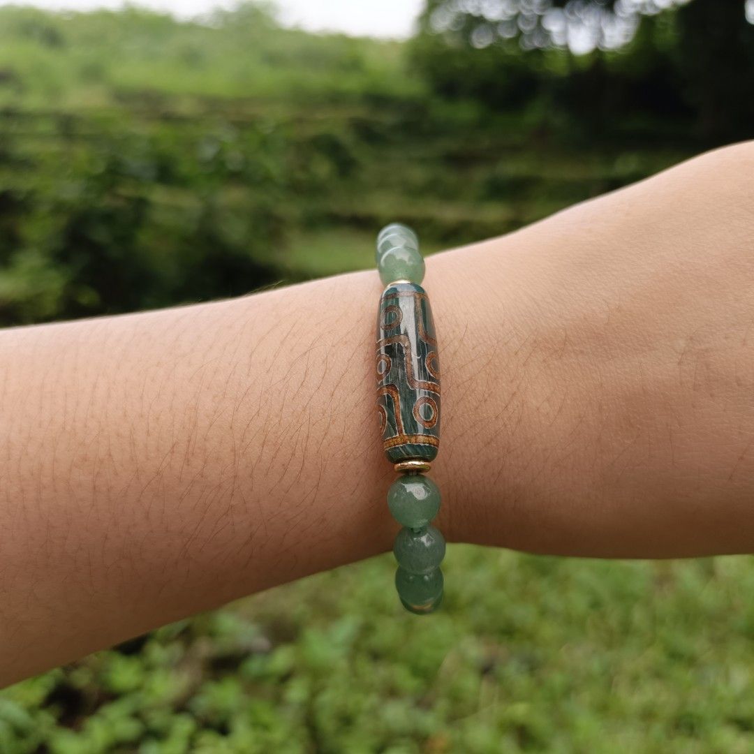 DZI + Aventurine (Category: Bracelets) located in Manila. Submitted by enchantra_gems (Listing ID 1465917128, Image 3). Description: ✨ DZI & AVENTURINE NATURAL STONE BRACELET 💚 A beautiful combination of Aventurine and a DZI bead, blending earthy elegance with timeless style. 💚 Aventurine: Associated with luck, growth & prosperity 🤎 DZI: Traditionally regarded as a symbol of protection & good fortune 📏 Bead Size 8 mm 🤍 Wrist Size: 16-17cm 💰