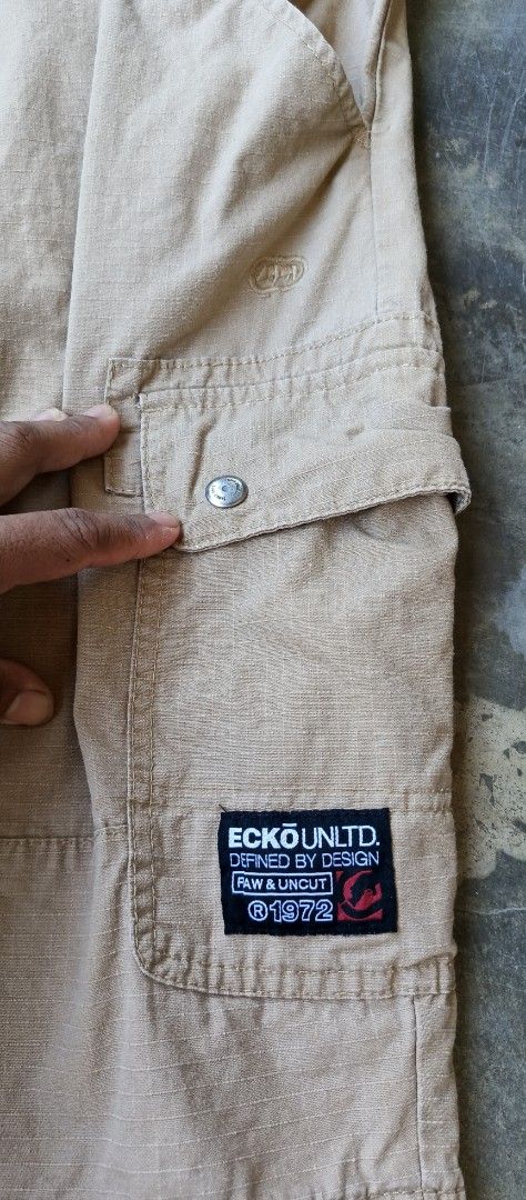 Ecko Unltd Cargo Shorts Beige Size 38 (Category: Shorts) located in Manila. Submitted by sandobag (Listing ID 1465819941, Image 2). Description: - Size: W 40-42 L 23 -Excellent condition - Color rate:10/10 Tan cargo shorts from Ecko Unltd. Size 38 on the tag, 100 percent cotton material made in Bangladesh. Multiple pockets on the sides and back, button closure, belt loops. Ecko branding patch on the left cargo pocket and embroidered logo above th