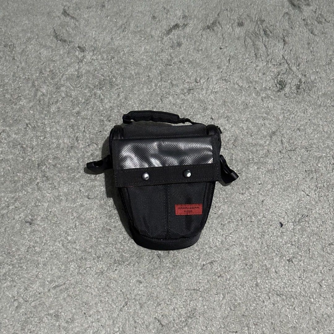 Elecom Graphgear Camera Bag Holster Case Black (Category: Camera Bags & Carriers) located in Lipa City. Submitted by jecoparra (Listing ID 1465840556, Image 1). Description: - Brand: Elecom Graphgear - Color: Black - Condition: Excellent / Pre-loved (ready to use) - Material: Rugged exterior designed for durability and protection - Closure: Front flap secured with sturdy metal snaps - Portability: Features a durable top handle and side loops for 